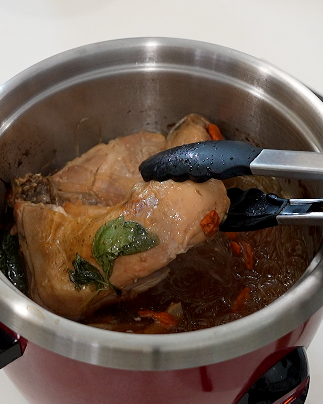 Simple herbal chicken with glass noodles in rice cooker, showing tender chicken and clear herbal soup