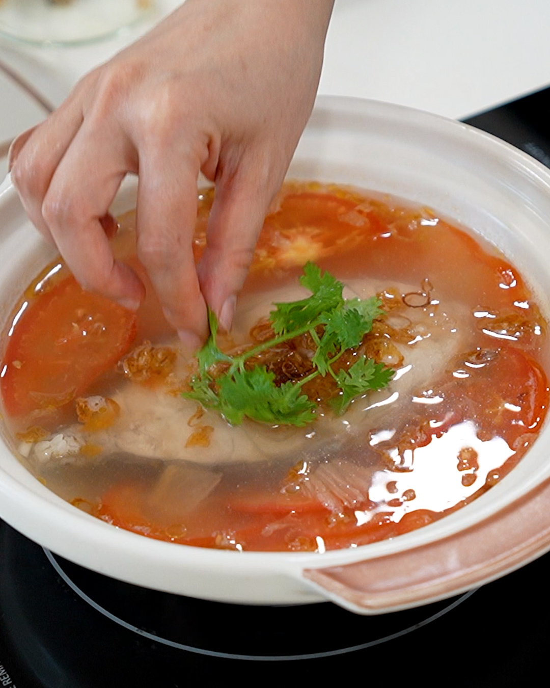 Simple Chinese fish soup with tomato and Tianjin preserved vegetables served alongside steamed white rice