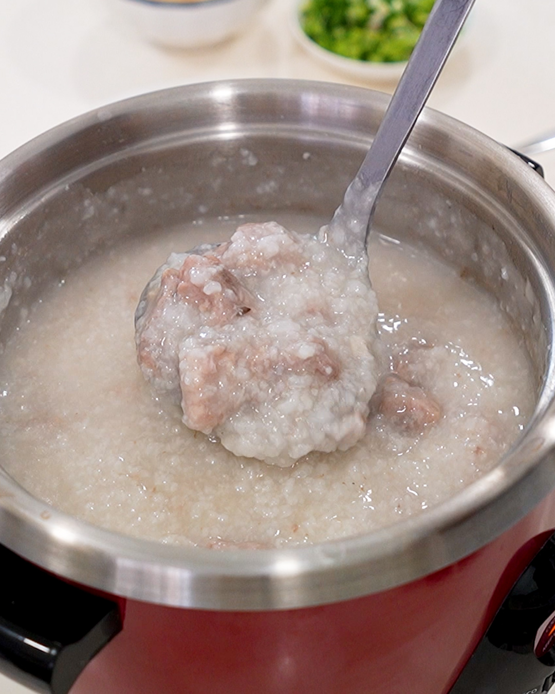 Creamy pork ribs porridge freshly cooked in a rice cooker, silky and thick texture