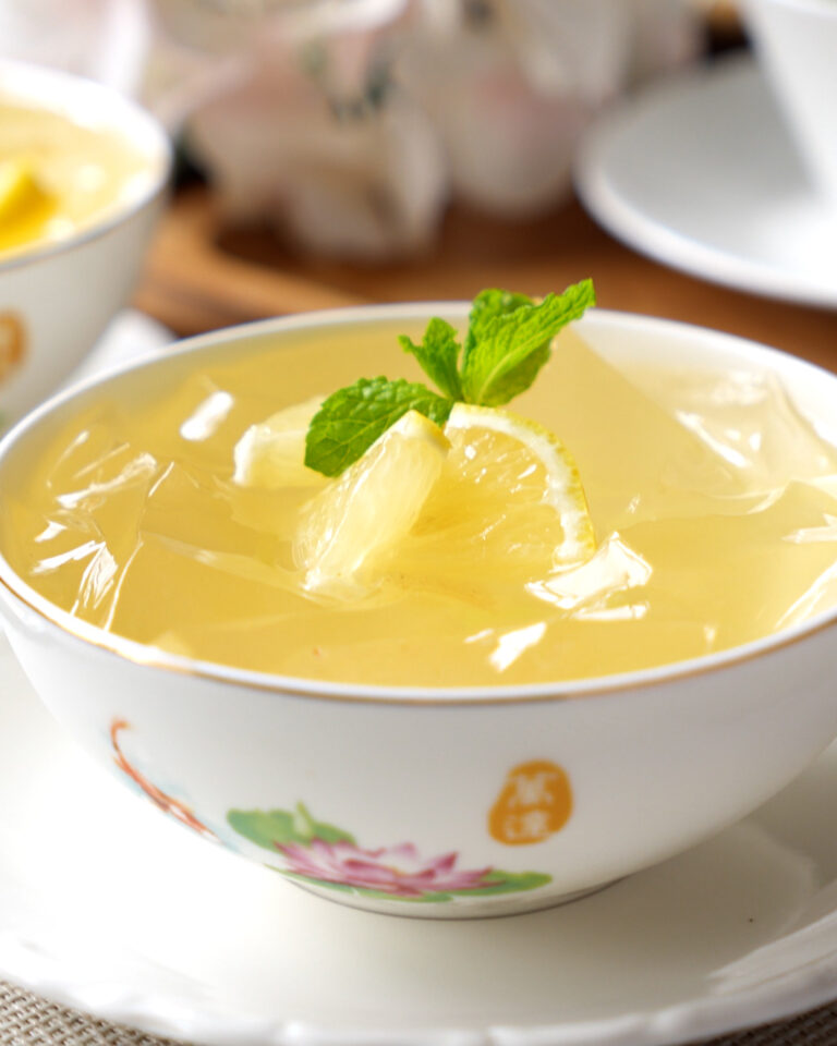 Aiyu jelly with osmanthus honey served in a glass with lemon slices
