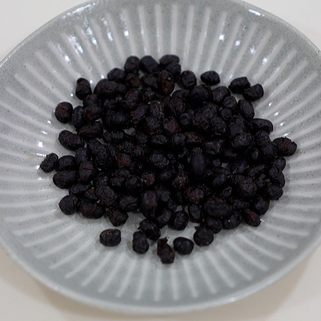 Fermented black beans on a plate top view used in steamed pork ribs with fermented black beans recipe