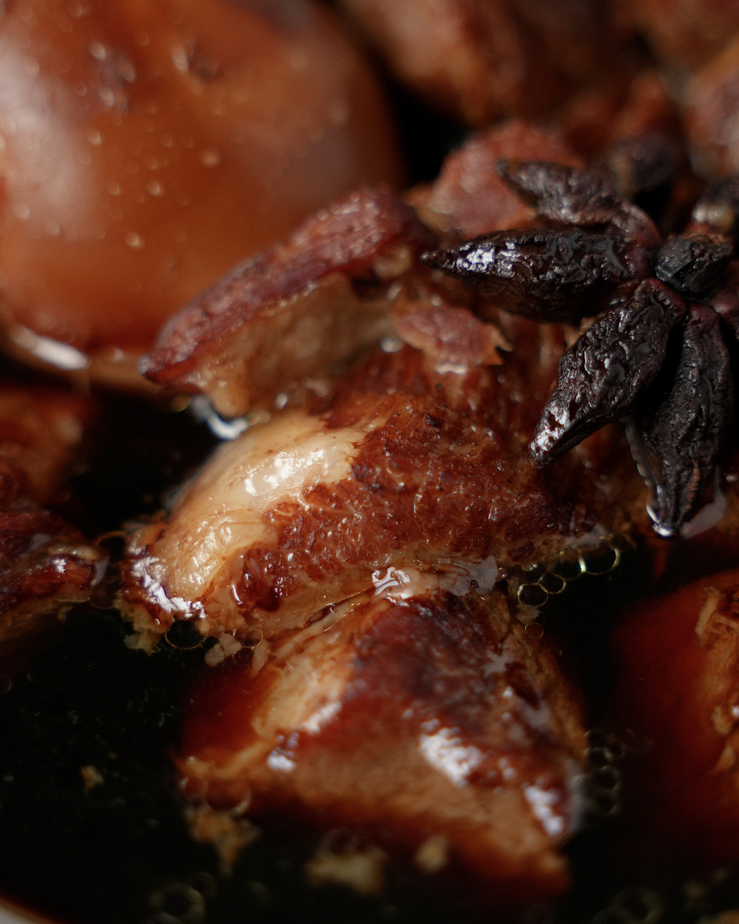 Tau yu bak braised pork simmering in soy sauce broth with hard boiled eggs