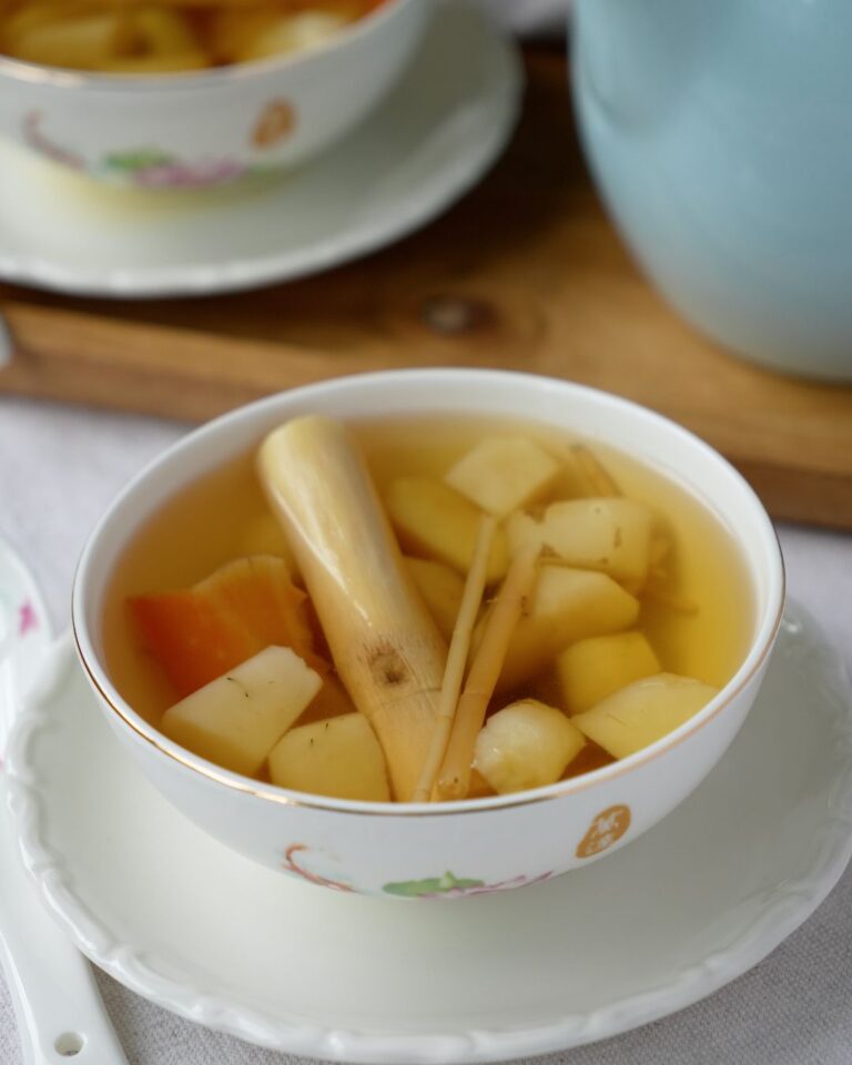 Water chestnut sugar cane drink served in two bowls with a jug of the drink