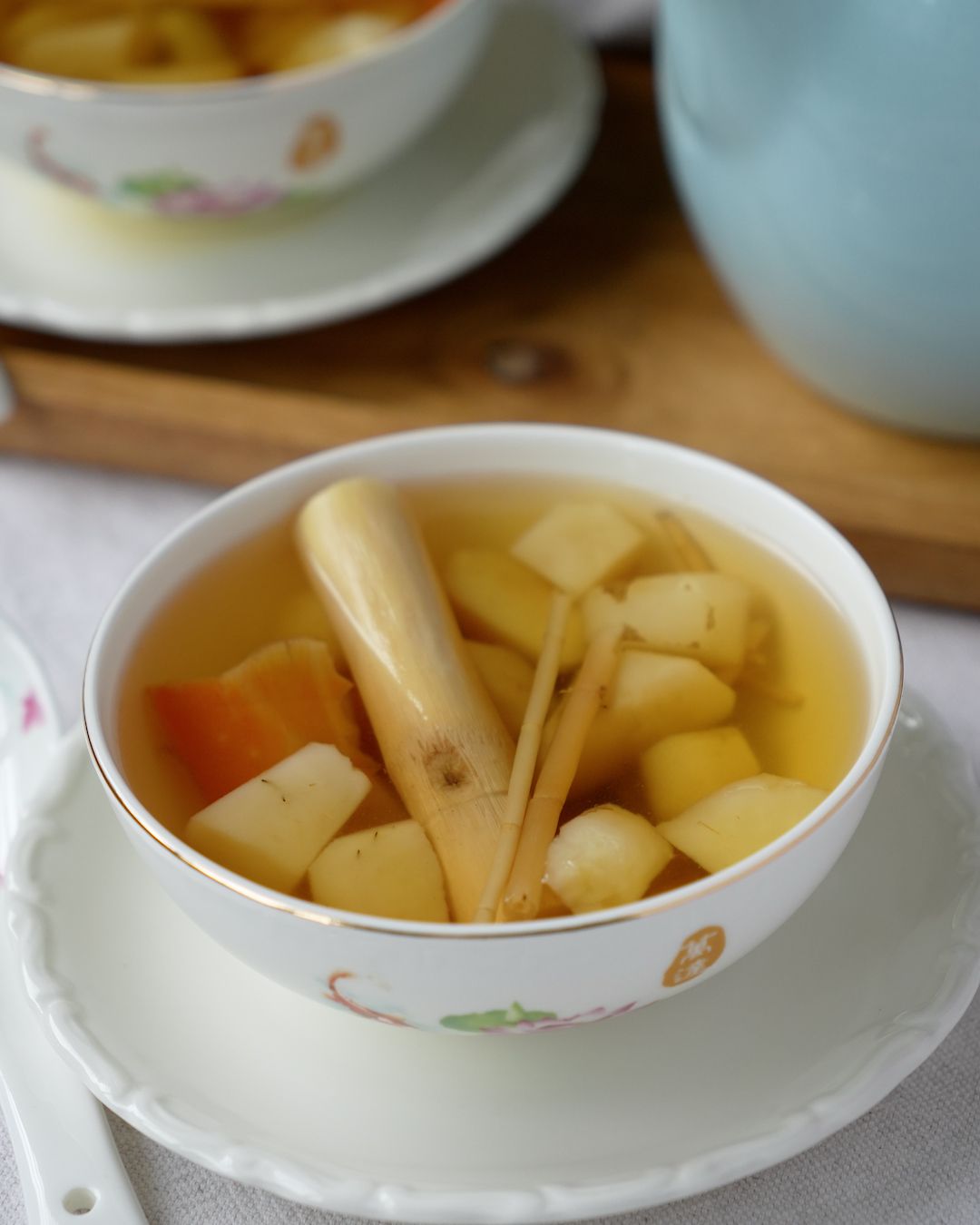 Water chestnut sugar cane drink served in two bowls with a jug of the drink
