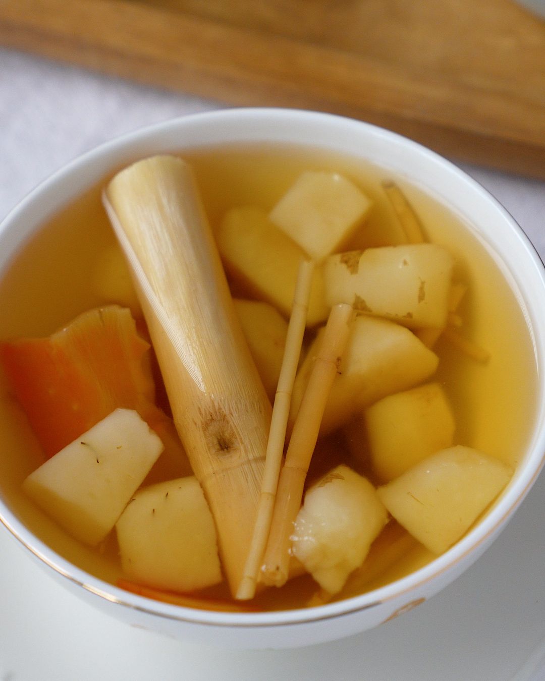Water chestnut sugar cane drink close up in a bowl with sugar cane, water chestnut, carrot and arrowroot