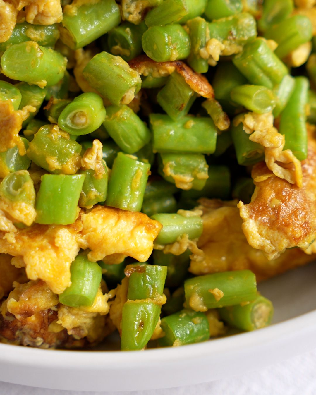 French beans with egg stir fry close-up showing the crispy egg pieces