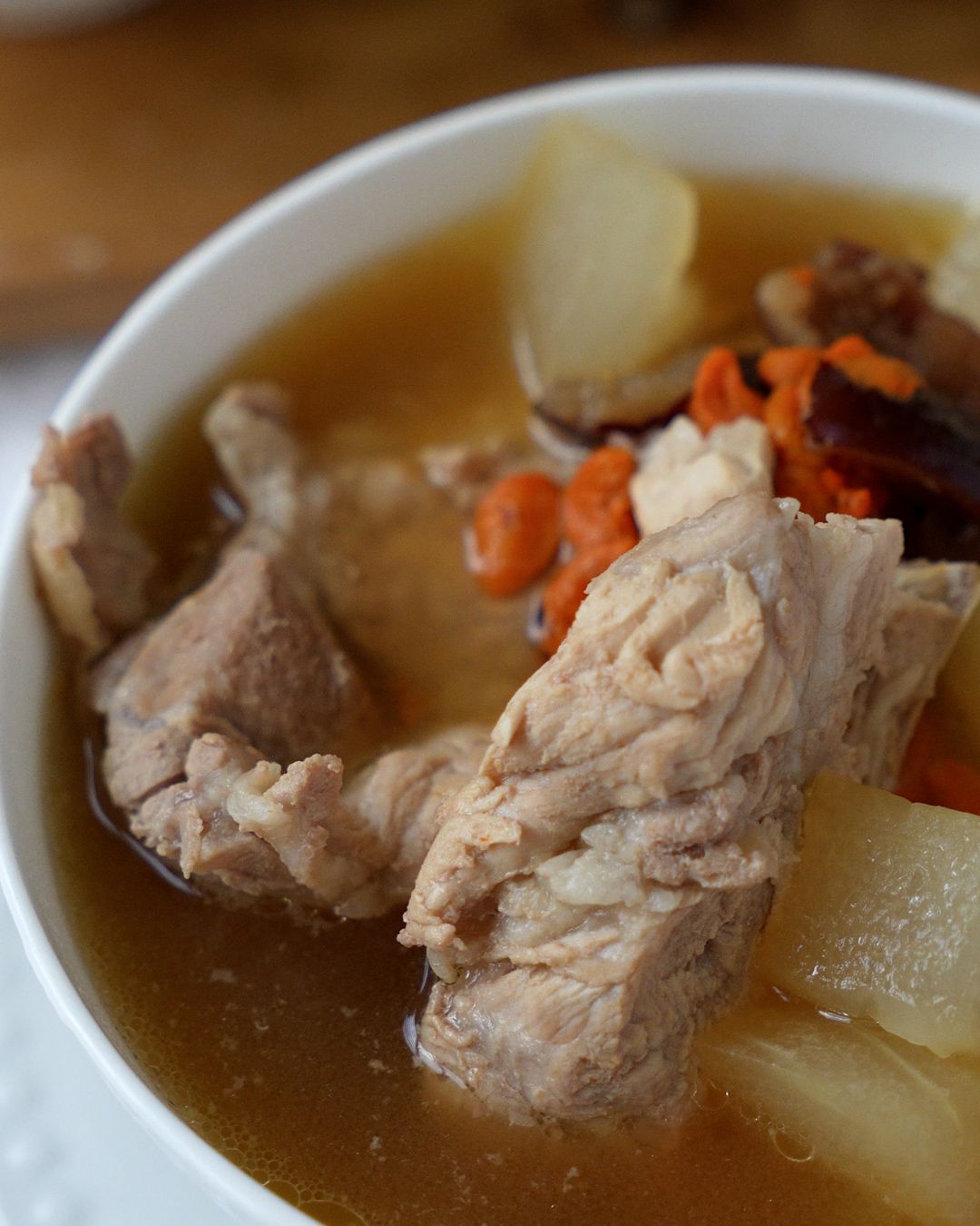 Pork ribs and winter melon simmering in a pot of clear soup broth