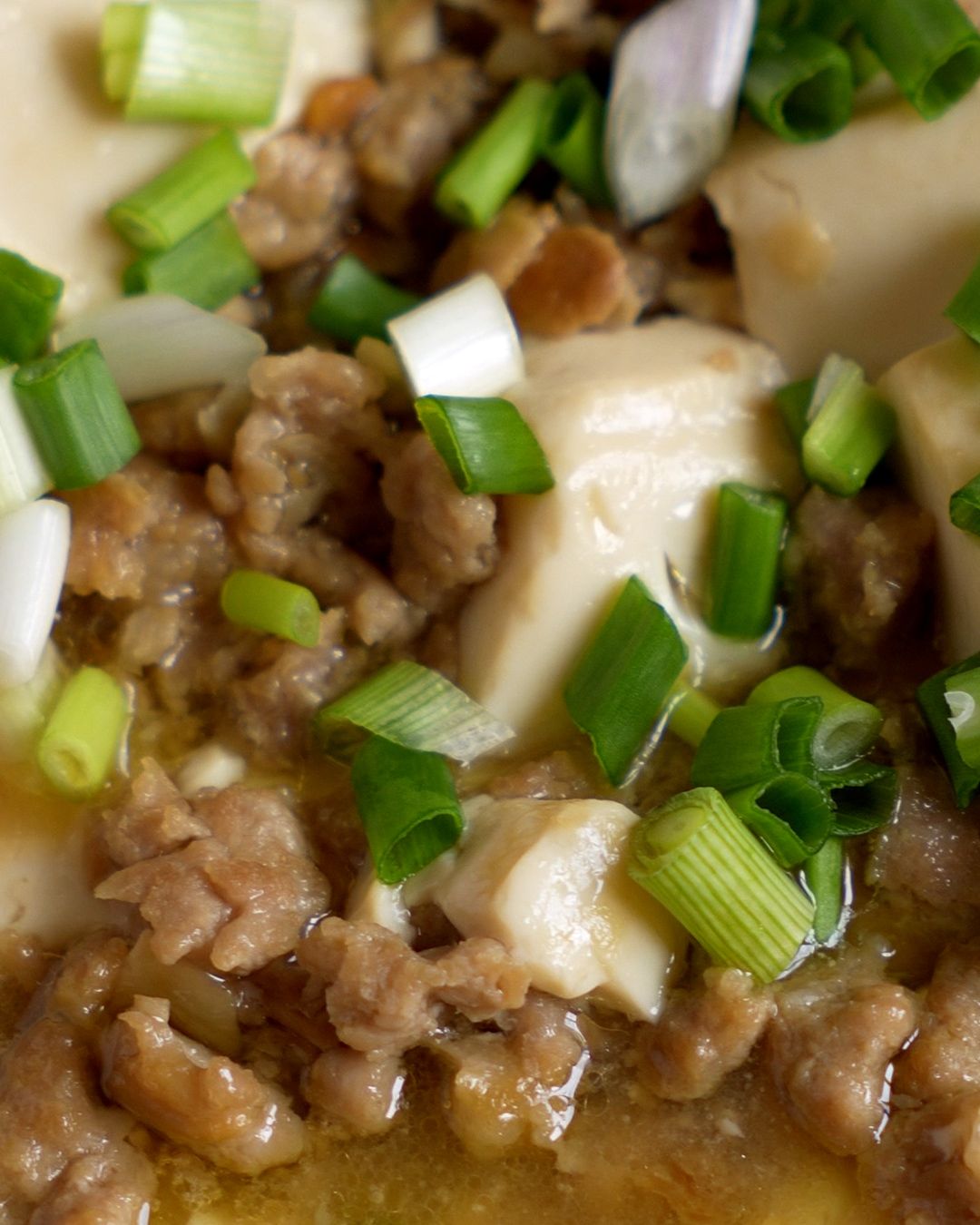 Minced pork and fermented bean paste sauce cooking in a pan for silken tofu recipe
