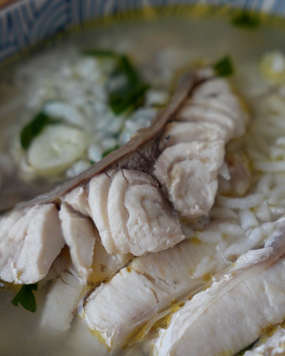 Close up of fish slices and leftover rice in sour plum fish soup