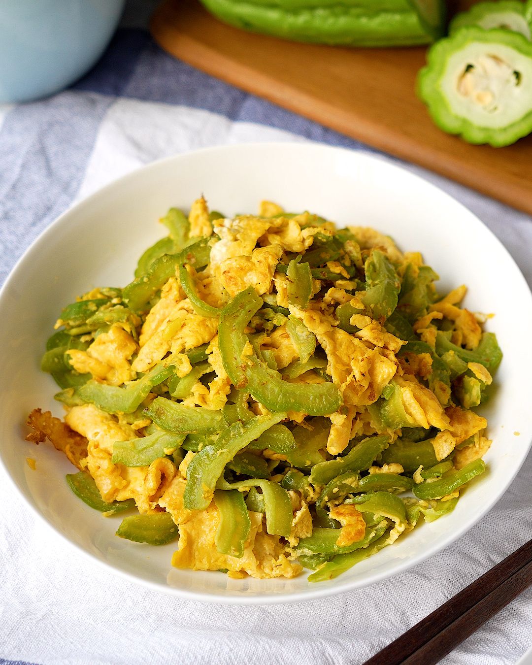 Bitter gourd stir fry with egg served in a white bowl