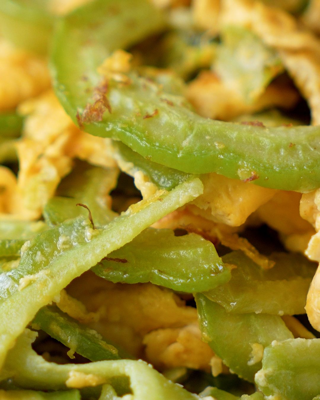 Close up of thinly sliced bitter gourd stir fried with egg
