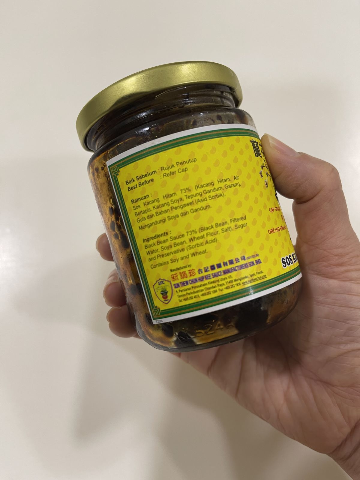 Back label of Orchid Brand fermented black bean paste showing the ingredients: black bean sauce, soya bean, wheat flour, salt and sugar